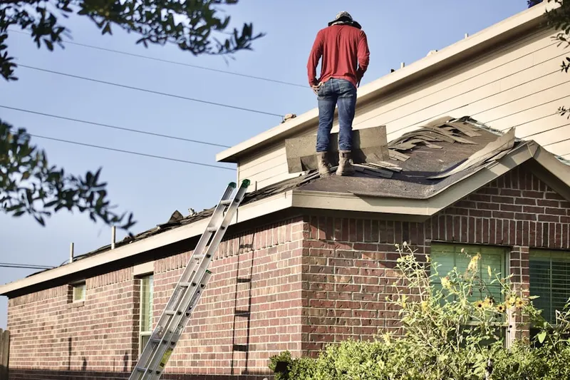 Professional roofer working on a residential roof in Huston